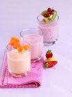 Different milkshakes in glasses on table — Stock Photo