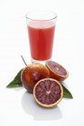 Blood oranges and glass of juice — Stock Photo