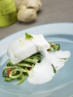 Cod fillet on cucumber medley — Stock Photo