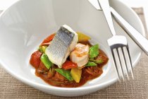 Sea bass and prawns with vegetables — Stock Photo