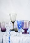 Elevated view of various drinking glasses on white tablecloth — Stock Photo