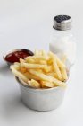 Potato fries with ketchup and salt — Stock Photo