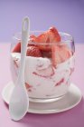 Closeup view of strawberry quark in glass with spoon — Stock Photo