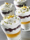 Closeup view of quark desserts with pomegranate and pistachios in glasses — Stock Photo