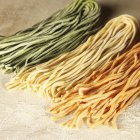 Homemade coloured tagliatelle pasta — Stock Photo