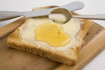 Buttered toast with honey — Stock Photo
