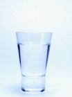 Closeup view of schnapps glass on bright background — Stock Photo