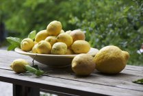 Fresh ripe Lemons in bowl — Stock Photo