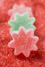 Jelly stars on red sugar — Stock Photo