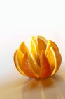 Orange cut into sections — Stock Photo
