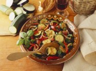 Ratatouille in brown bowl with wooden spoon — Stock Photo
