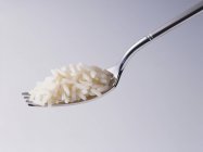 Cooked rice on fork — Stock Photo