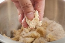 Closeup cropped view of hand making crumble topping — Stock Photo