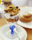 Yoghurt with fruit and cornflakes — Stock Photo