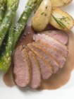 Duck breast with asparagus and rosemary potatoes — Stock Photo