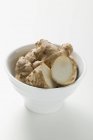 Fresh ginger roots in bowl — Stock Photo