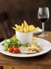 Chicken breast with potato fries — Stock Photo