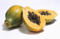 Papaya fresca madura con mitades - foto de stock