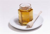 Vaso di miele con paletta — Foto stock