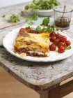 Portion of lasagne with roasted tomatoes — Stock Photo