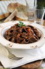 Chocolate tagliatelle pasta with boar ragout — Stock Photo