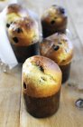 Closeup view of Panettones with raisins on wooden surface — Stock Photo