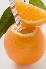 Orange fruit with straw — Stock Photo