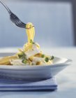 Thin ribbon pasta with cream sauce — Stock Photo