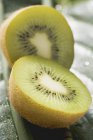 Kiwi fruit on green leaf — Stock Photo
