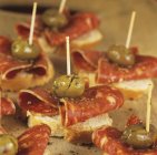 Canaps with chorizo and green olives — Stock Photo