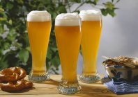 Glasses of wheat beer on wooden table — Stock Photo