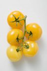 Five yellow cherry tomatoes — Stock Photo