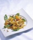 Tagliatelle pasta salad with oranges — Stock Photo