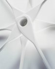 Closeup view of white corner spoons arranged in a star shape — Stock Photo
