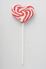 Heart-shaped candy cane lollipop — Stock Photo