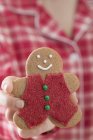 Gingerbread man in hands — Stock Photo