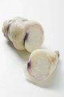 Oca, cut into two pieces  on white surface — Stock Photo