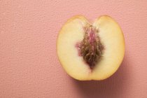 Half peach with stone — Stock Photo