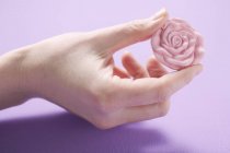 Closeup view of rose pink soap in female hand — Stock Photo