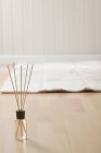 Aromatic incense sticks and mat on parquet floor — Stock Photo