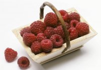 Raspberries in wooden basket — Stock Photo