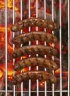Sausages on barbecue rack — Stock Photo