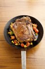 Beefsteak with vegetables in pan — Stock Photo