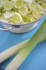 Leeks with slices in metal bowl — Stock Photo
