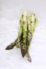 Green asparagus in water — Stock Photo
