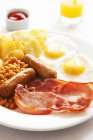 Closeup view of English breakfast with orange juice and ketchup — Stock Photo