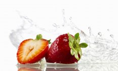 Erdbeeren mit Spritzwasser — Stockfoto
