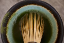 Closeup view of Matcha tea with a tea whisk — Stock Photo