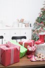 Christmas gifts on kitchen table — Stock Photo