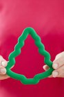 Woman in holding green cookie cutter — Stock Photo